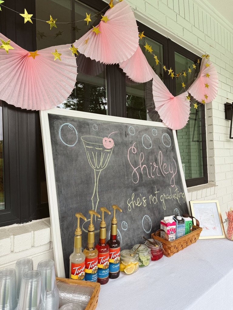 dirty soda bar chalkboard sign and streamers and syrups