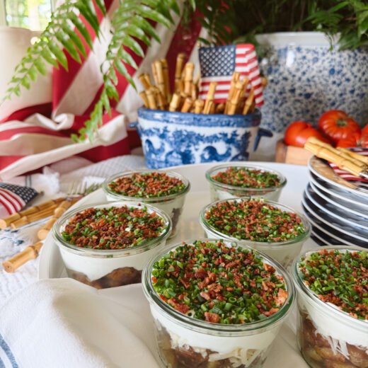 fourth of july table with crispy potato parfaits in glass jars