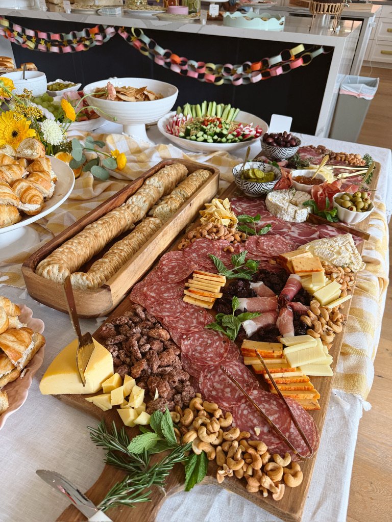 food table with charcuterie dips and decorations