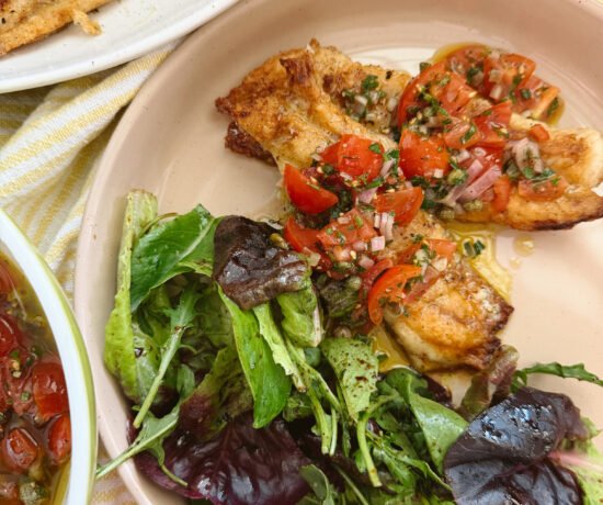 Pan seared snapper with fresh vierge sauce on a cream plate