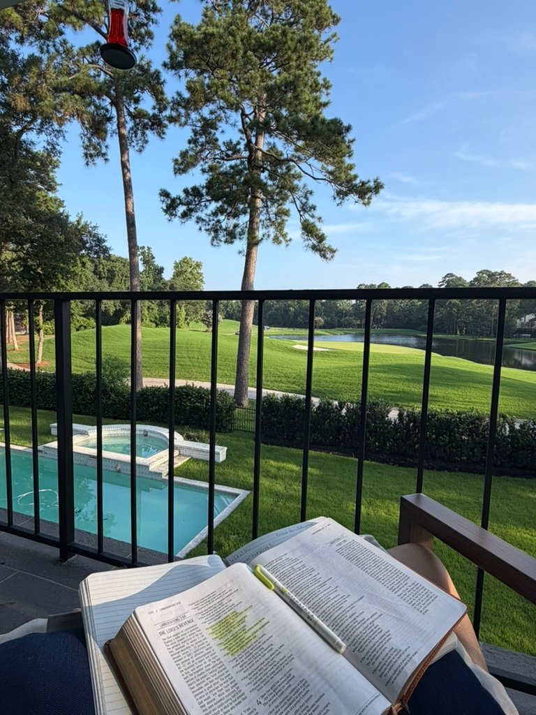 reading bible outside looking at pool