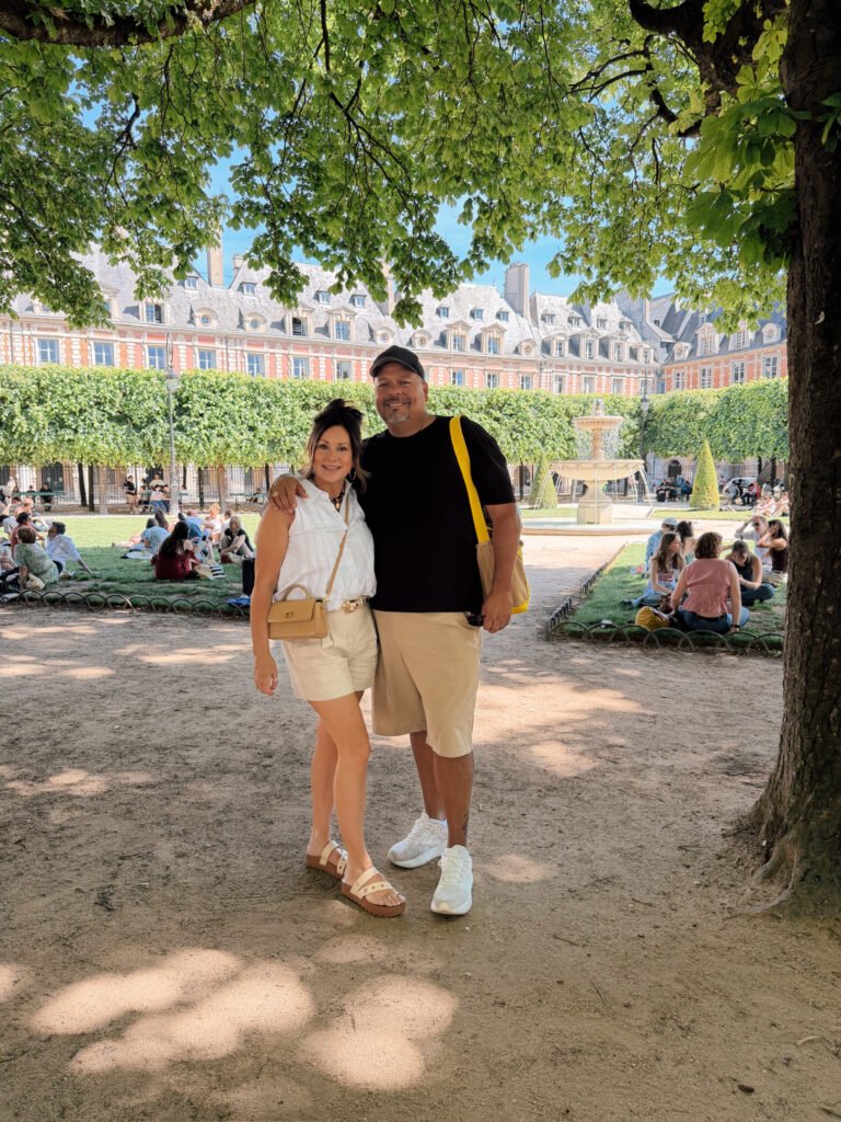 couple in Paris park with people on blankets