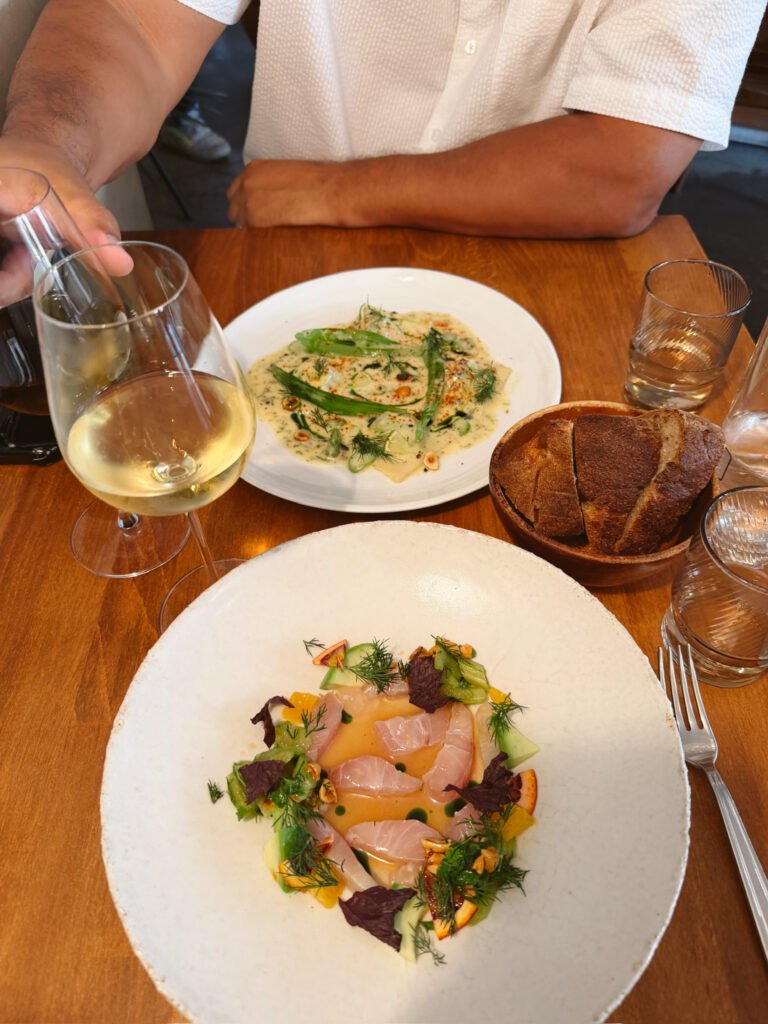 fresh seasonal pasta and crudo on white plates