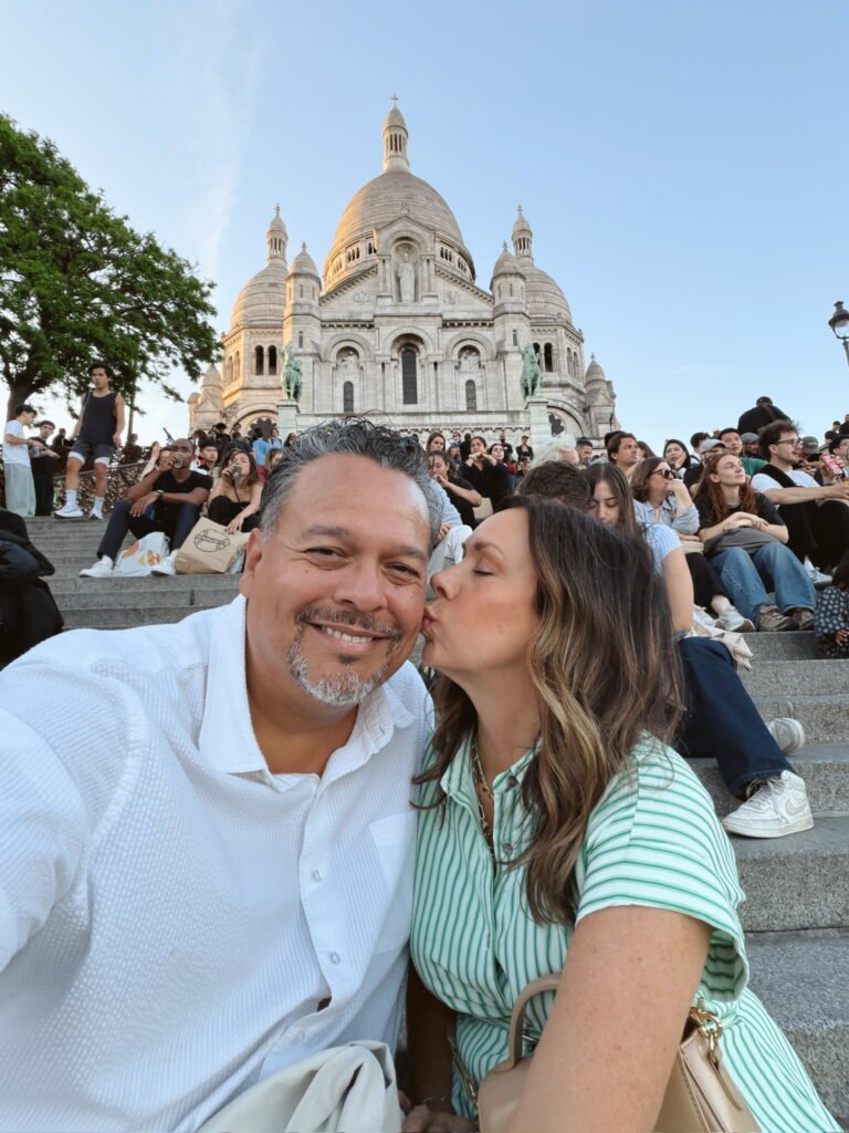 couple kissing in front of notre dame in france