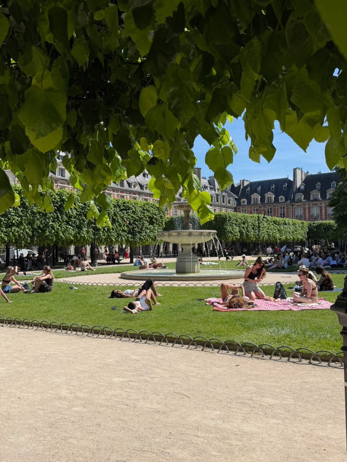 people on blankets in the sun in a Paris park