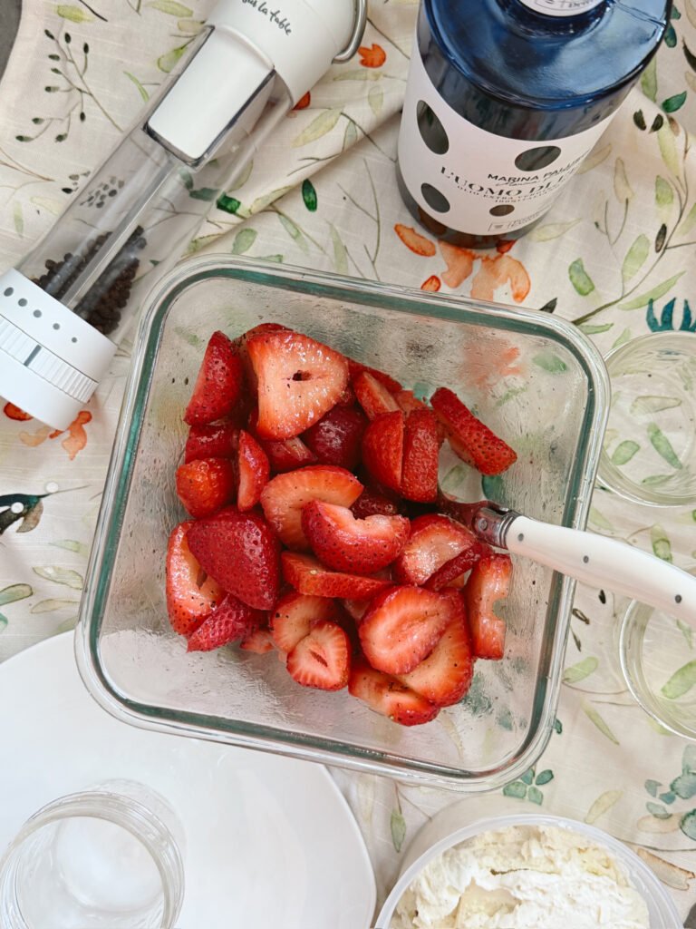 macerated strawberries with pepper grinder and olive oil