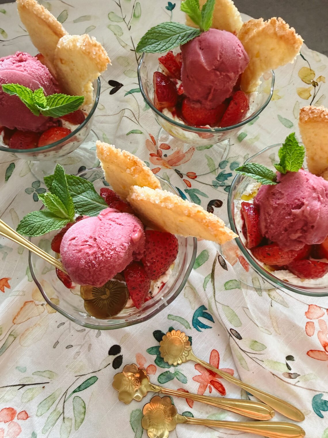 strawberry cream parfaits with shortbread and raspberry sorbet in glasses