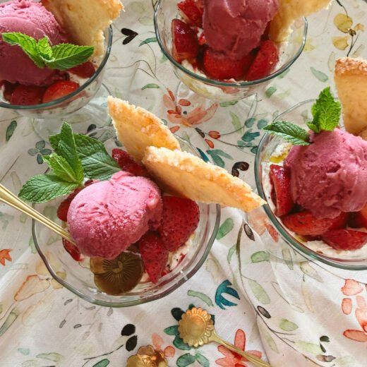 strawberry cream parfaits with shortbread and raspberry sorbet in glasses