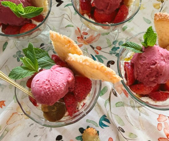 strawberry cream parfaits with shortbread and raspberry sorbet in glasses